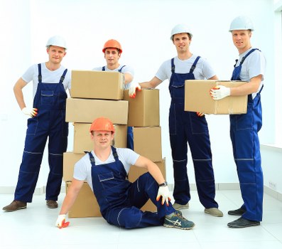 Local movers unloading boxes at a Belmont home