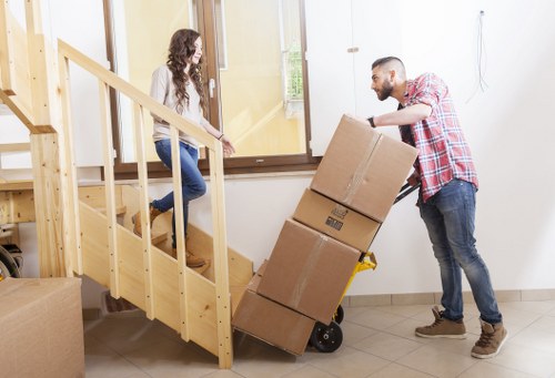 Packed household boxes and furniture prepared for a Belmont move